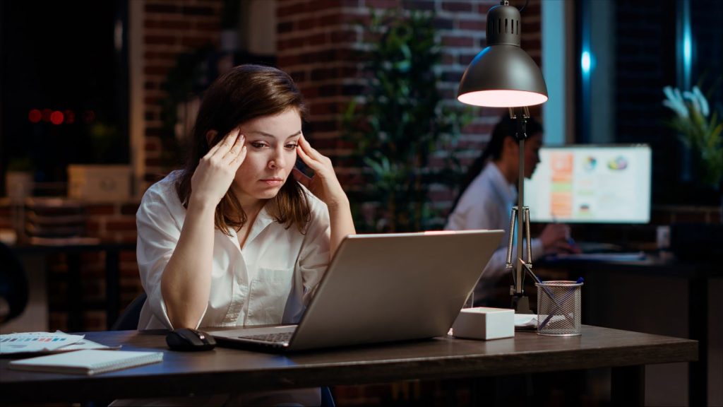 Tired employee struggling slow internet connection